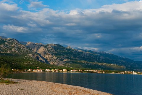 Coastline with mountains in the background under a cloudy sky, Starigrad, Starigrad-Paklenica,