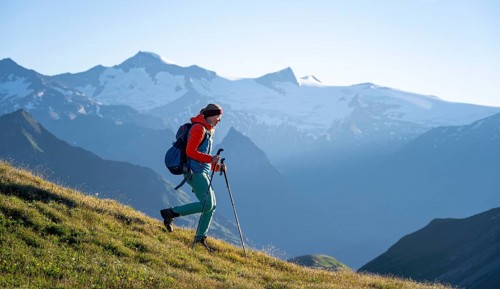 Hiker enjoying the mountain panorama in the morning, Venediger group, behind Dreiherrenkopf,