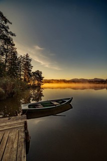 Boats in the autumnal Schmutter Weiher in the Allgäu near the municipalities of Halblech,