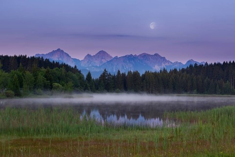 Idyllic lake at dusk with mountains and forests in the background, Hegratsrieder See, Ostallgäu,