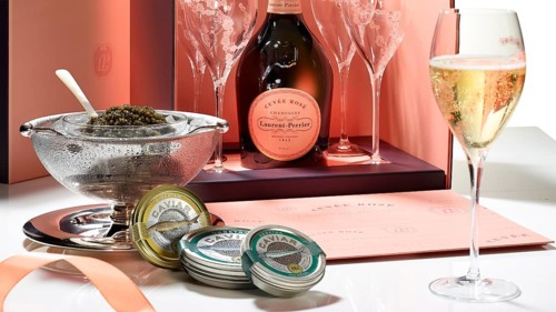 Champagne bottle with glasses, caviar, caviar tins, studio shot