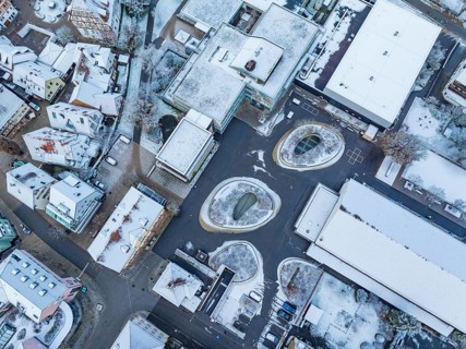 Aerial view of a snow-covered roofscape in an urban environment, cold winter atmosphere, Nagold,