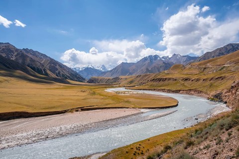 Mountain river in a valley, picturesque mountain landscape with white mountain peaks, Tian Shan
