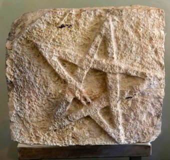 Five point star inscribed in stone, from Kutza, Late classic period, Mayan archaeological museum,