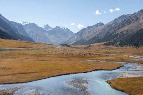 Mountain river in a picturesque mountain valley, mountain landscape with white mountain peaks, Tian
