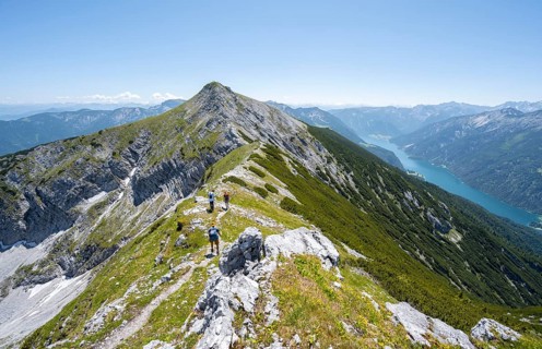 Mountaineer on the hiking trail on the summit ridge of the Unnütz, behind Achensee, Unnütz