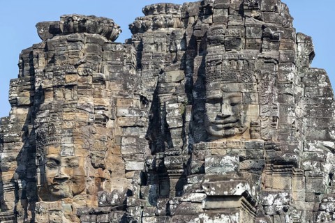 Panoramic image of giant stone-carved faces of the Bodhisattva Lokeshvara, also known as