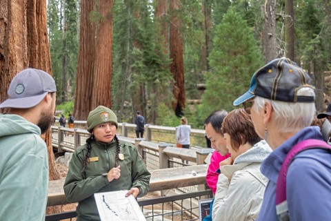 Yosemite National Park, California - A National Park Service worker talks to visitors at the