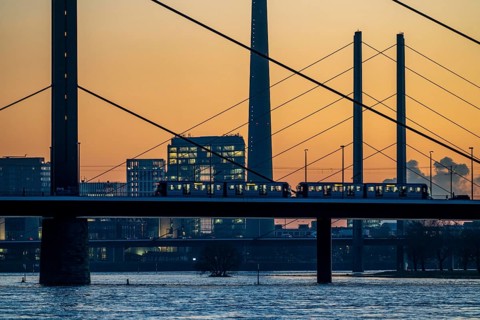Sunset on the Rhine near Düsseldorf, skyline of the city centre with Rhine Tower, Rheinkniebrücke,
