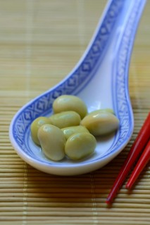 Edamame, unripe soya beans in an Asian ceramic spoon, Glycine max