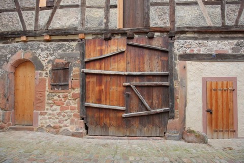 House wall with gates and doors, historic building, wooden construction, beams, wooden gate,