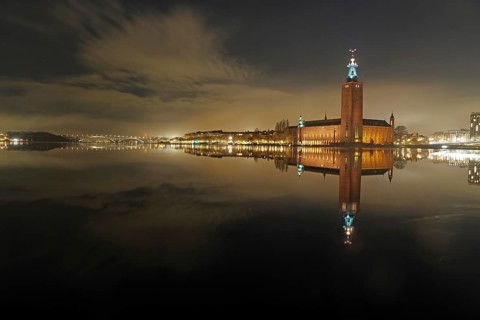 Night city view with illuminated tower and bridges in the background, winter, ice, capital, city