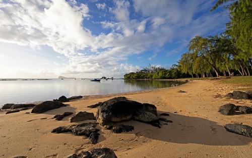 Golden sandy beach on the Indian Ocean near Calodyne, with Gunner's Coin Island in the background,