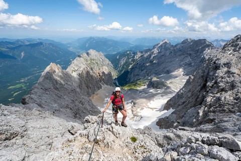 Mountaineer with helmet in a secured via ferrata, Zugspitze via ferrata, ascent to the Zugspitze,