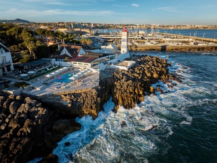Aerial view of Santa Marta lighthouse and Cascais marina with moored yacht boats with Cascais