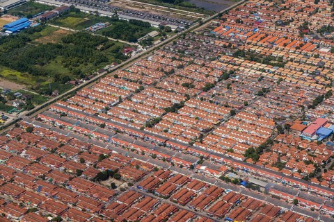 Retort city in the north-east of Bangkok. Standardised houses stand close together on the straight