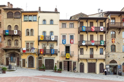 Piazza Grande with houses from different eras with wooden balconies and coats of arms, Arezzo,
