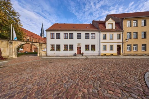 Marienstern Monastery, wall with archway, houses with windows and pointed roofs made of roof tiles,