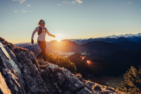 Trail running in autumn on the Jochberg on Lake Walchensee against the wonderful backdrop of the