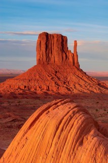 Monument Valley with majestic red sandstone formations in the desert under a clear sky in sunlight,