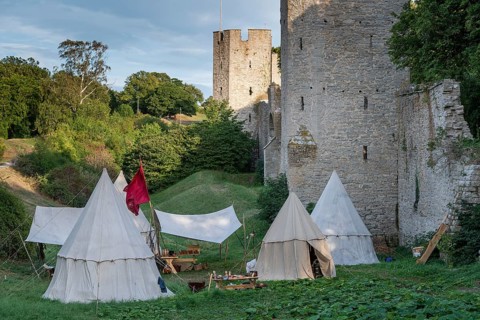 Camp in front of historic city walls with defence towers, Medieval Week, Hanseatic City of Visby,