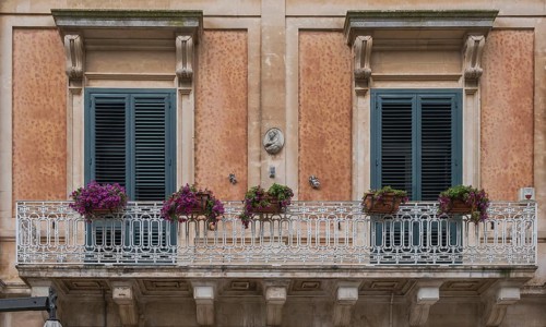 Historic building with balcony and floral decoration, Martina Franca, Apulia, Italy, Europe
