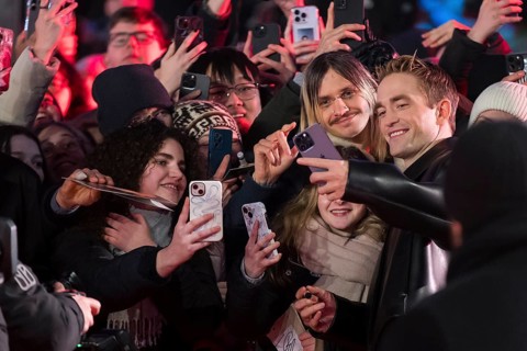 Robert Pattinson takes selfies with fans on the red carpet at the Special Gala of the film Mickey