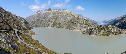 Grimselsee or Lake Grimsel with the historical Hotel Grimsel Hospiz near the Grimsel Pass in the