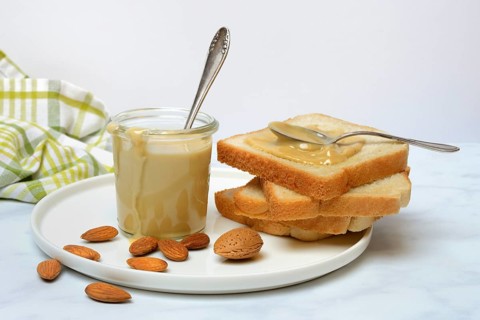 Almond cream in a jar and toast