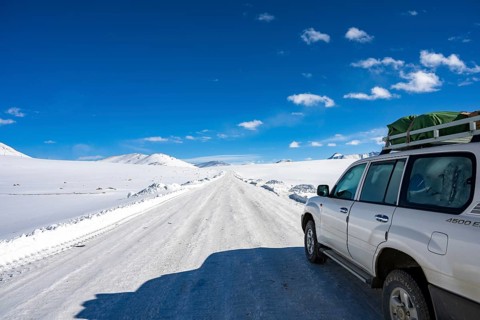 Off-road vehicle on the wintry Pamir Highway, Gorno-Badakhshan Province, Tajikistan, Central Asia,