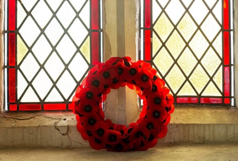 Poppy wreath in church window Remembrance events, Framsden church, Suffolk, England, UK