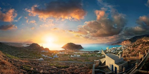 Panoramic view of Arkasa town on the coast, illuminated by a dramatic sunset, Arkasa, Karpathos,