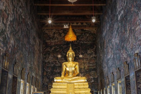 Golden Buddha statue, Phra Buddha Trilokachet, surrounded by exquisite murals, interior view of the
