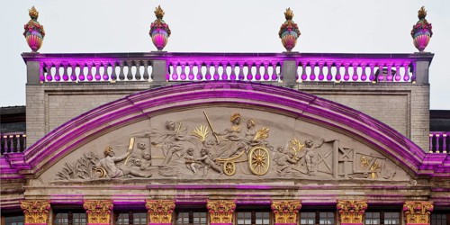 The illuminated gable of the guildhall Le Moulin à Vent and Pot d'Étain in the evening,