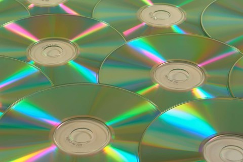 Several CD-ROMs with rainbow effect on the surface, close-up