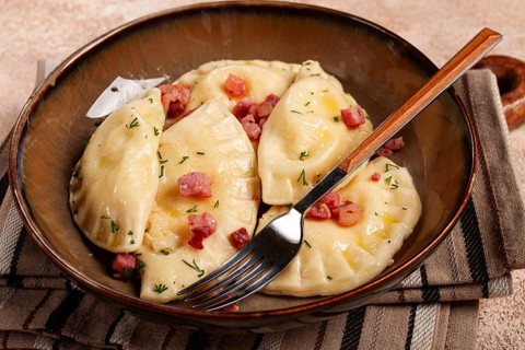 Dumplings, with fried prosciutto, a traditional dish of Polish cuisine, dumplings, top view,