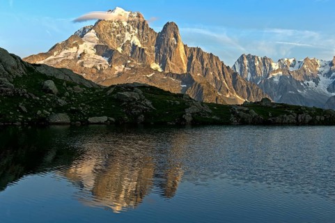 Reflection of the peaks Aiguille Verte and Aiguille du Dru in the mountain lake Lacs des Chéserys