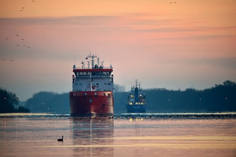 Ships, tanker, cargo ship meet at sunrise in the Kiel Canal, NOK, Kiel Canal, Schleswig-Holstein,