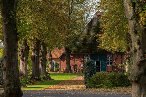Farmhouse, half-timbered house in Barsbek, Probstei landscape, group of trees in autumn leaves,