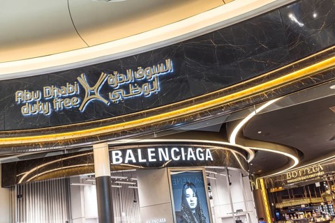 Abu Dhabi Airport, Zayed International Airport with passengers. Duty free shop of the fashion brand