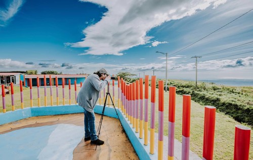 Person photographing landscape with a digital camera in a park. Photographer photographing a