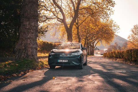 Car in the sunlight on an autumnal avenue, electric car VW ID5, Deer Carsharing, Gechingen, Black
