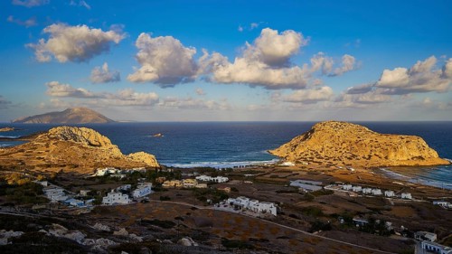 View of coastal village with white houses and rock formations in the background, Acropolis Hill,