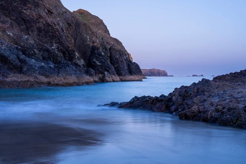 Kynance Cove in the evening, with sea, sandy beach and rocks. Blue hour. Long exposure. Good