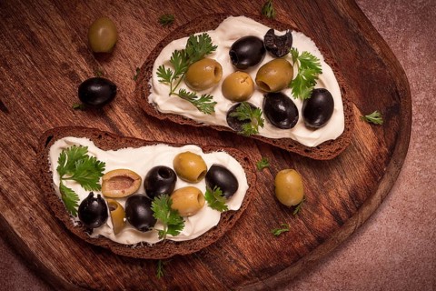 Breakfast, sandwiches, with cream cheese, olives, top view
