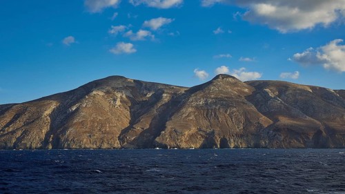 View of a rocky coastline under a clear blue sky, Kassos Island, neighbouring island of Karpathos,