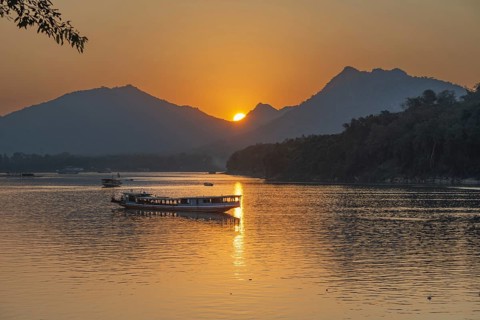 Sunset on the Mekong with excursion boats, near Luang Prabang, Laos, Asia
