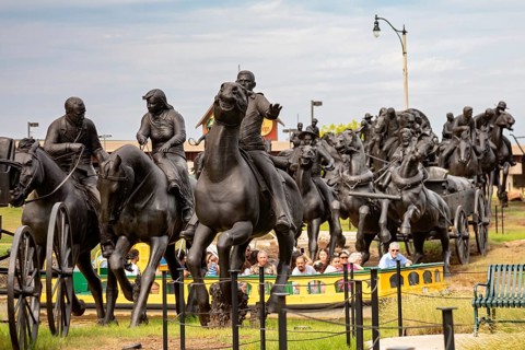 Oklahoma City, Oklahoma - Tourists in a canal boat ride through a sculpture commemorating the