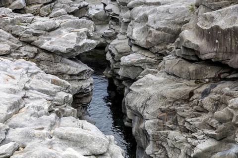 Rocks, granite rock formations in the Maggia River near Ponte Brolla, in the Maggia Valley, Valle