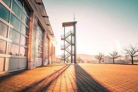 Municipal fire station with striking training tower in the sunlight, Althengstett, district of